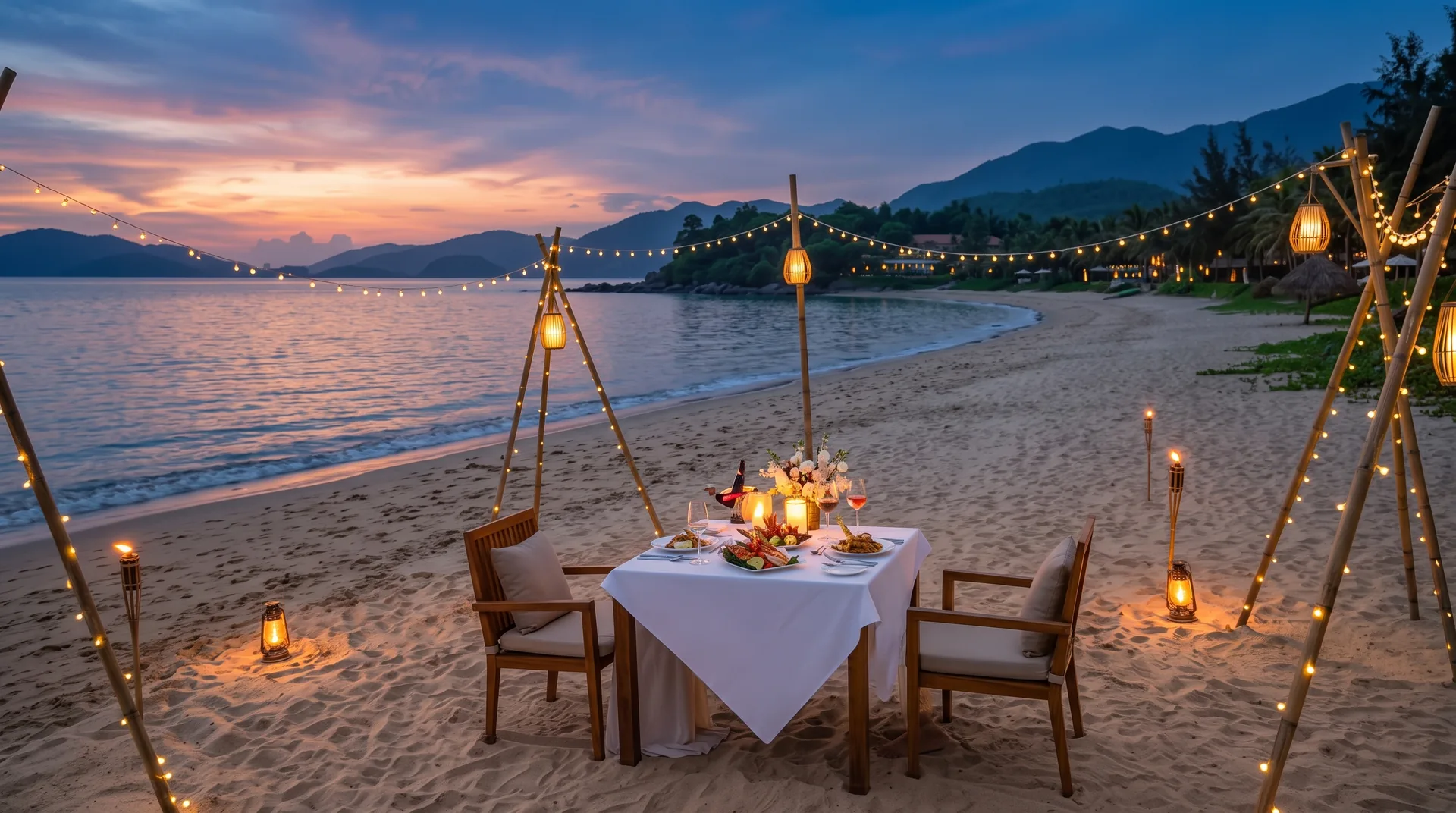 Candlelit dinner table on the beach at sunset at Langco Bay Retreat
